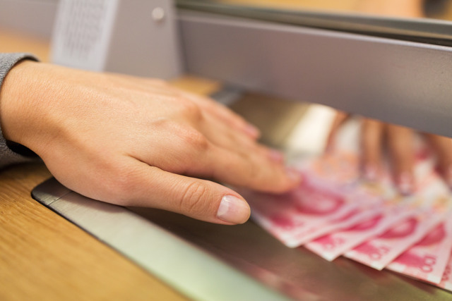 clerk giving cash money to customer at bank office